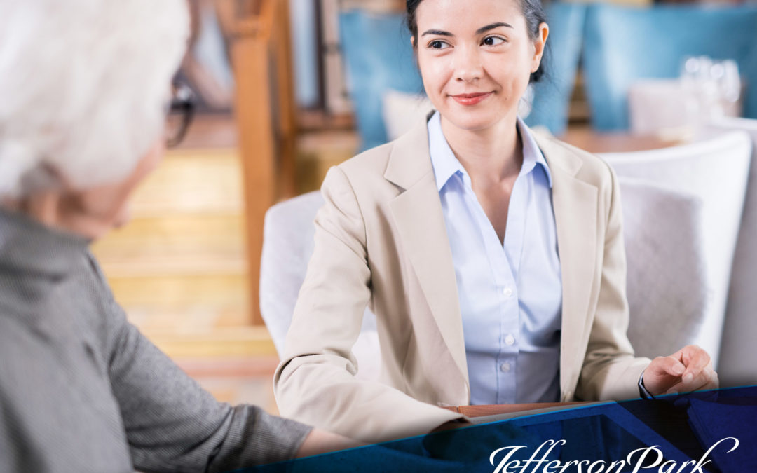 insurance saleswoman discussing long-term care insurance benefits with an elderly woman